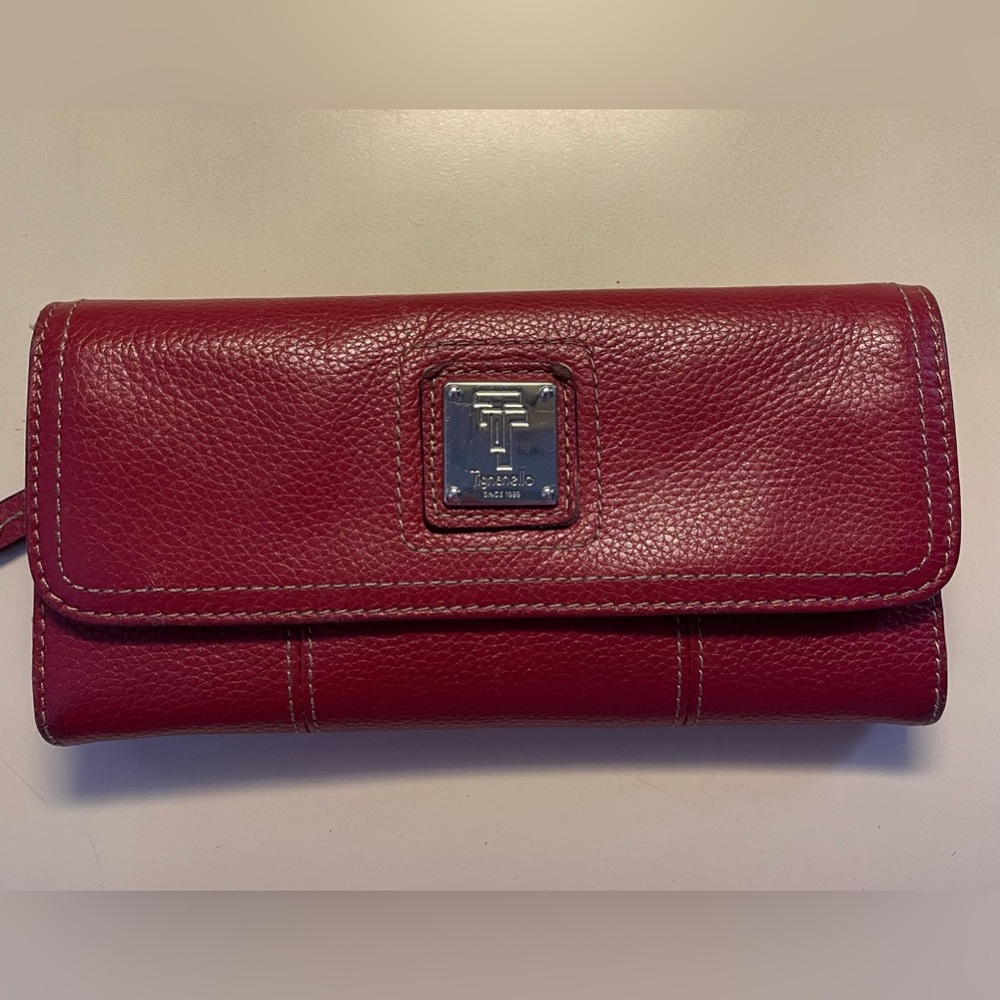 Red Tignanello wallet with snap closure and outer zip pocket.
